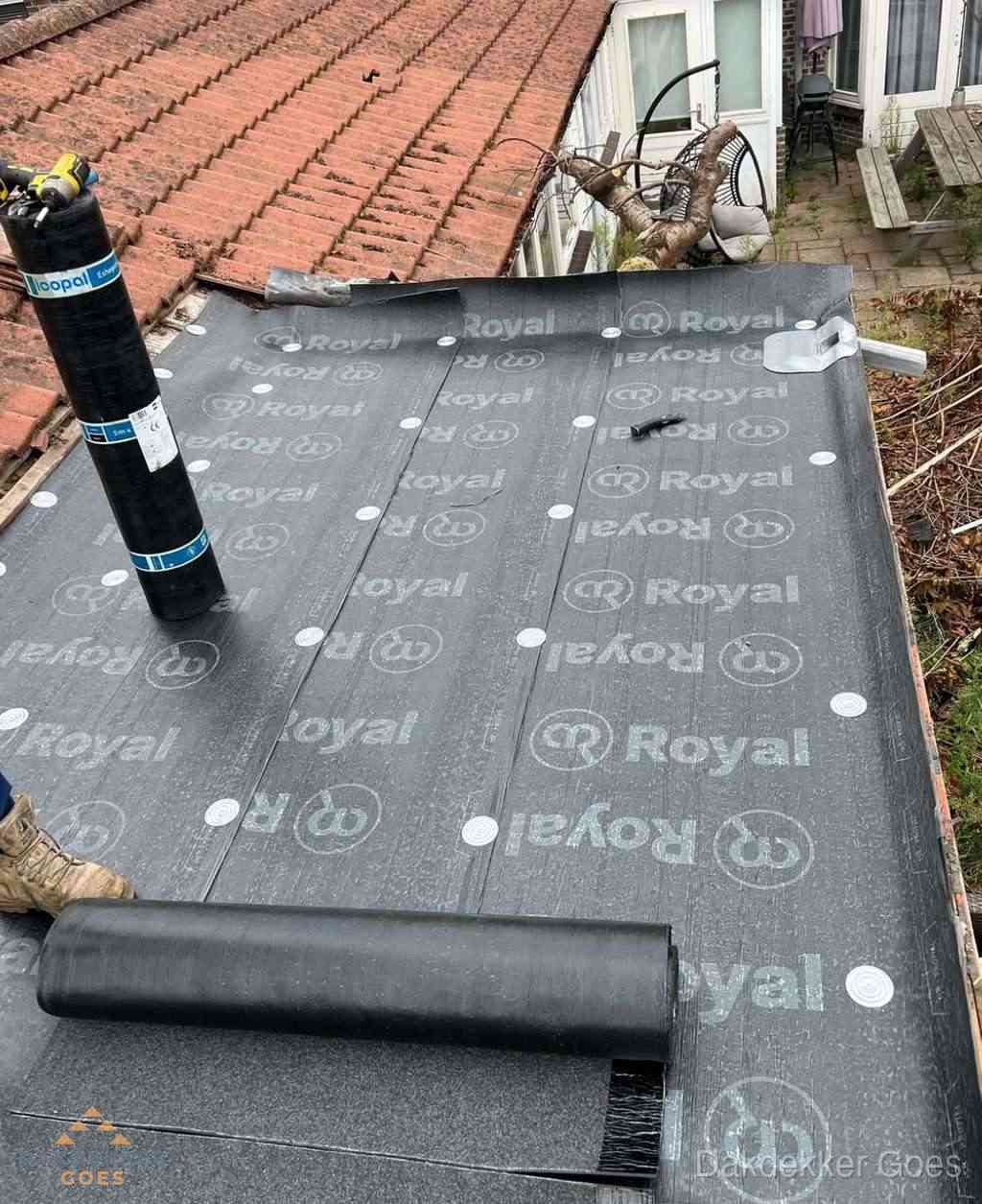 Plat dak met nieuwe bitumen dakbedekking en brandgereedschap in Goes